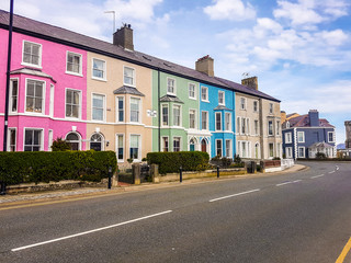 Brightly colored terraced houses on street in Wales