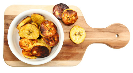 Roasted Plantains on Cutting Board Over White © Ixepop