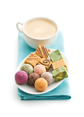 Various sweet candies and coffee cup.