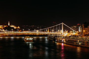 Fototapeta na wymiar Night view of the bridge with night lights in Barcelona. Night river