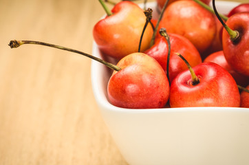 sweet cherry in a white bowl/shiny sweet cherry in a white bowl