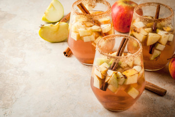 Autumn and winter drinks. Warm apple sangria, apple cider with pieces of fruit, cinnamon, spices,...