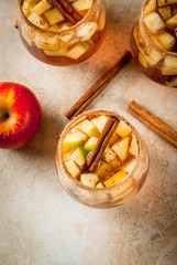 Autumn and winter drinks. Warm apple sangria, apple cider with pieces of fruit, cinnamon, spices,...