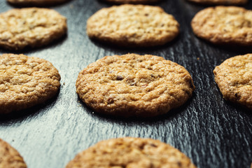 Biscuit sweet cookie background. Domestic stacked butter biscuit pattern concept,close up macro.Homemade cookies on wooden table.Cereal biscuits with the sesame,peanuts,sunflower and amaranth.