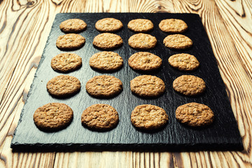 Biscuit sweet cookie background. Domestic stacked butter biscuit pattern concept,close up macro.Homemade cookies on wooden table.Cereal biscuits with the sesame,peanuts,sunflower and amaranth.