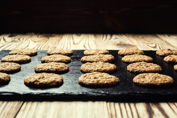 Biscuit sweet cookie background. Domestic stacked butter biscuit pattern concept,close up macro.Homemade cookies on wooden table.Cereal biscuits with the sesame,peanuts,sunflower and amaranth.