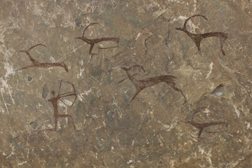 Figure animals and hunter on the stone wall of the cave paint ocher ancient prehistoric Neanderthal. prehistoric animal, stone age hunting for deer. primitive man