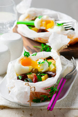 Vegetables with sausages in parchment.