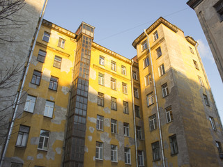 Large yellow town house with plastered walls