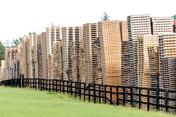 Wooden pallets piled up high at a pallet factory in Ireland.