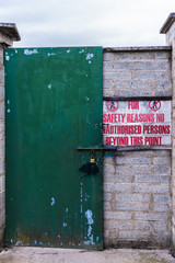 Sign at the locked steel door at an industrial site "for safety reasons no unauthorised persons beyond this point".