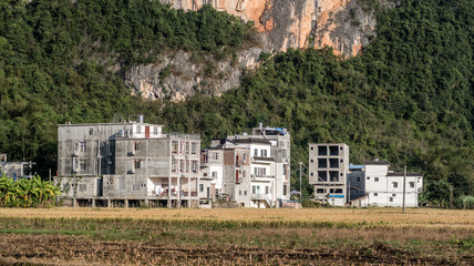 Fototapeta na wymiar Contemporary Village Architecture Amidst Lush Greenery in Guangxi Region, China