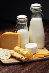 milk products - tasty healthy dairy products and milk jar, glass