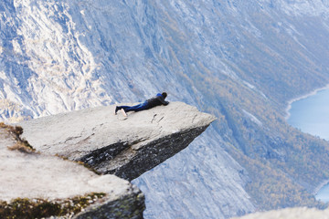 Man lying on a rocky outcrop, Trolltunga, Odda, Hordaland, Norway