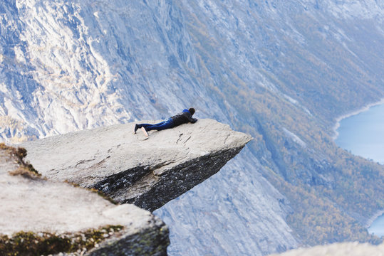 Man lying on a rocky outcrop, Trolltunga, Odda, Hordaland, Norway