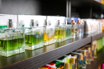 Shelving with different perfume in modern shop