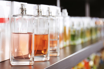 Shelving with different perfume in modern shop