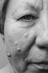 Elderly pensioner female half face portrait closeup