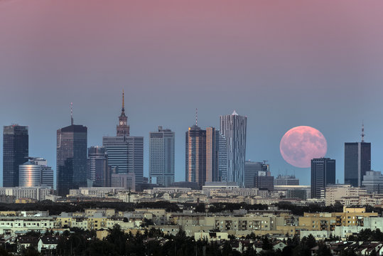 Rising moon over Warsaw city, Poland