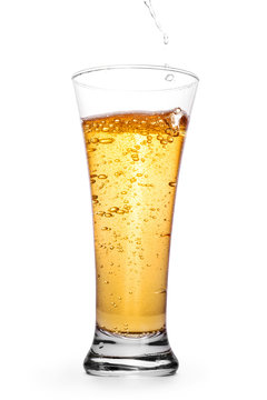 Beer in the glass with splash and bubbles