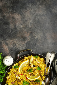 Traditional spanish (valencian) dish paella - stew with rice and seafood.Top view with copy space.