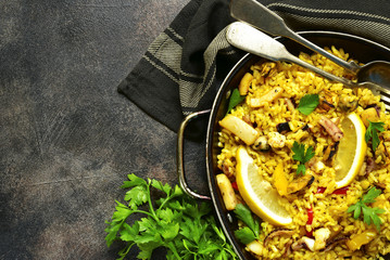 Traditional spanish (valencian) dish paella - stew with rice and seafood.Top view with copy space.