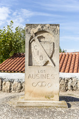 Fototapeta na wymiar Camino del Cid signpost with a shield and a sword in Los Ausines, Burgos, Spain
