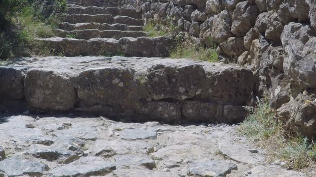 POV. point view of old stone steps of Chateau Queribus - one of the cathar castle in the Languedoc, France.