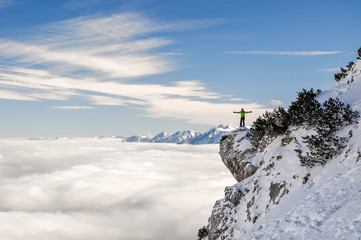 Stunning view of a hiker standing on a steep cliff near the Bavarian town of Garmisch Partenkirchen...