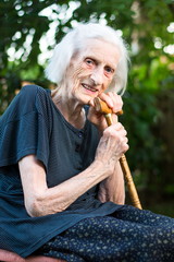 Cheerful senior woman with a walking cane