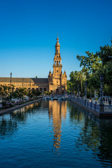 The tower in plaza de espana with reflection in water in Seville, Spain, Europe