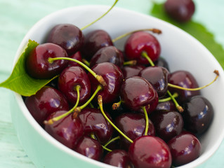 cherries on a turquoise wooden surface