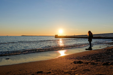 The girl is standing on the beach