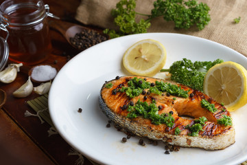 Salmon steak served on white plate