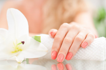 Obraz na płótnie Canvas Manicure concept. Beautiful woman's hand with perfect manicure at beauty salon.