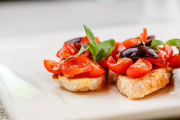 Italian bruschetta with chopped tomatoes, basil and olive