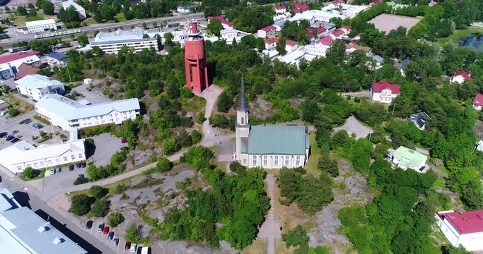 Hanko, Cinema 4k aerial orbit view around the church, revealing the city, on Hango regatta day, in Finland