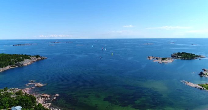 Hanko, Cinema 4k aerial view above hanko city and towards the racing sailboats, at the yacht competition, on Hango regatta day, in Uusimaa, Finland