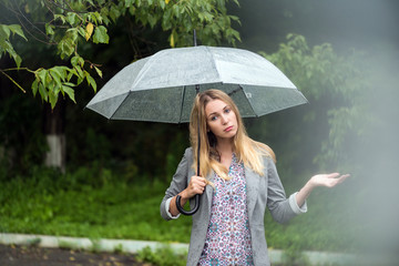 Girl with an umbrella in heavy rain