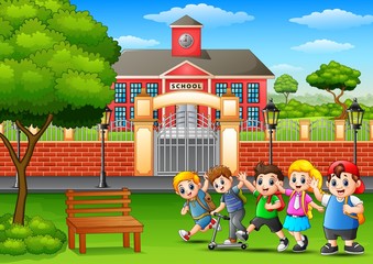 Fototapeta na wymiar Happy school children playing in front of school building