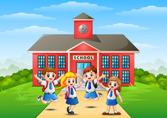 Obraz na płótnie Canvas Happy school children in front of school building