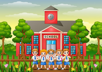 Obraz na płótnie Canvas Happy school childrens in front of school building