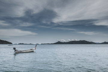 Fishing boat near andaman Ocean and Cloudy Sky for Vintage look