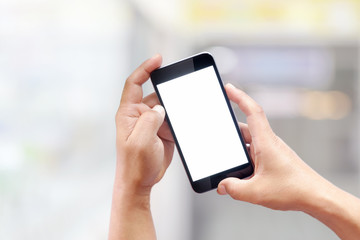 Man using smartphone at abstract blurred street night. Blank screen for graphics display montage.