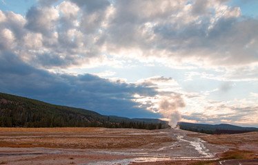 Old Faithful Geyser at dawn as seen from the Old Faithful Inn in Yellowstone National Park in...