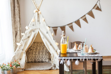 Decorated teepee and table set for breakfast