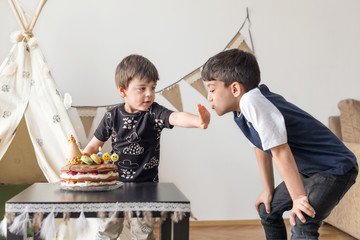Young boy blowing out birthday candle