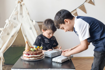 Brothers unpacking wrapped presents