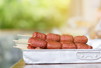 Meat Balls and Hot Dogs on stainless steel tray.
