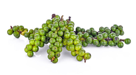 green peppercorns on white background